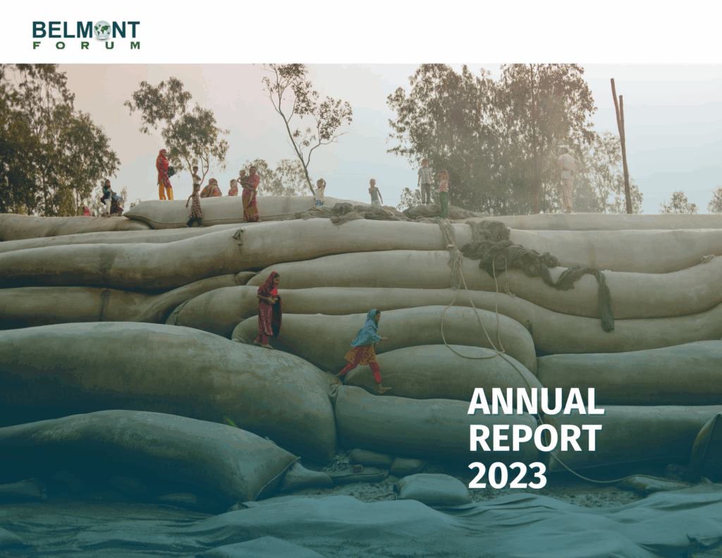 Cover of the Belmont Forum Annual Report 2023. The image shows people walking across large sandbags or barriers in a flood-prone area, with trees in the background and a hazy sky. The Belmont Forum logo appears in the top left corner, and the text "Annual Report 2023" is in bold white letters at the bottom right.